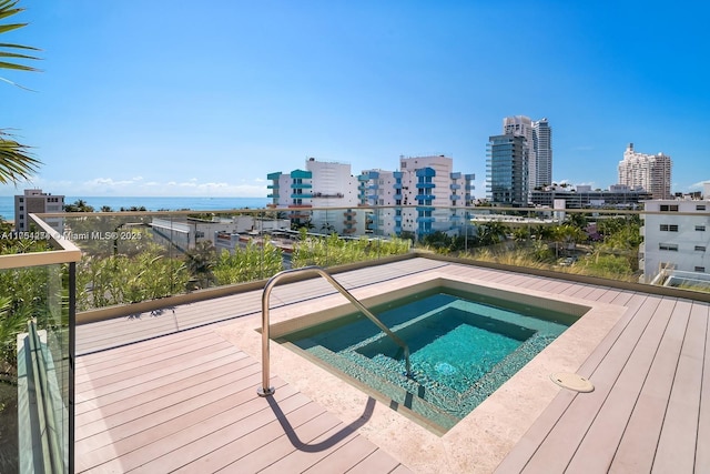 view of swimming pool with a hot tub and a city view