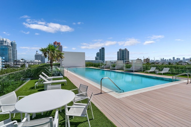 pool featuring a city view and a yard