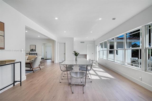 dining space featuring baseboards, light wood-style flooring, and recessed lighting