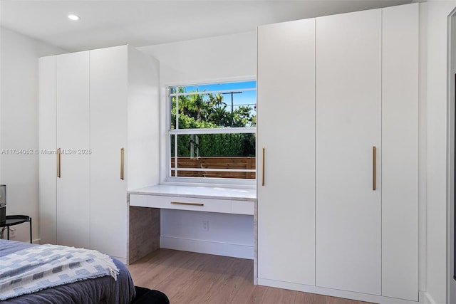 bedroom with recessed lighting and light wood-style floors
