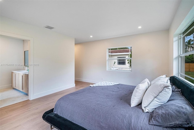 bedroom featuring light wood-style floors, recessed lighting, visible vents, and baseboards