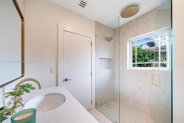 bathroom featuring a stall shower, visible vents, and vanity