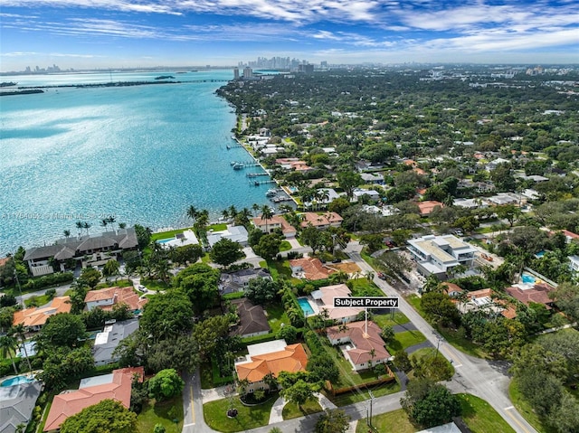 drone / aerial view with a water view and a residential view