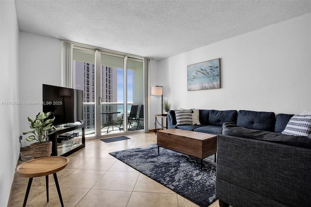 tiled living area featuring a textured ceiling and floor to ceiling windows