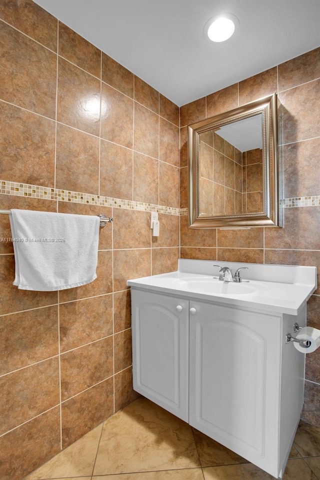 bathroom featuring tile patterned floors, tile walls, and vanity