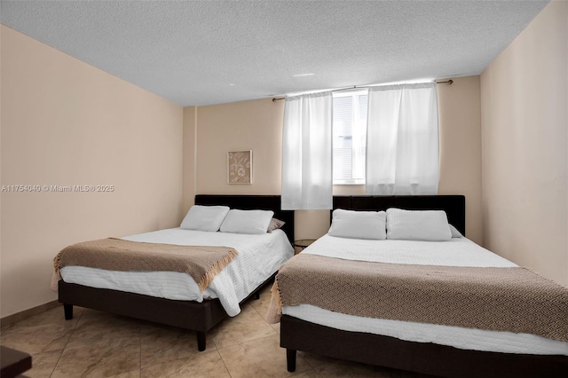 bedroom featuring light tile patterned floors and a textured ceiling