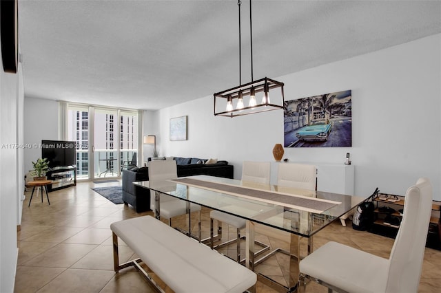 tiled dining space featuring floor to ceiling windows and a textured ceiling