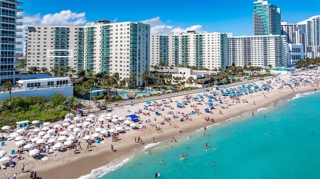 aerial view with a water view, a beach view, and a city view