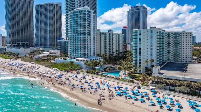 bird's eye view with a water view, a view of city, and a beach view