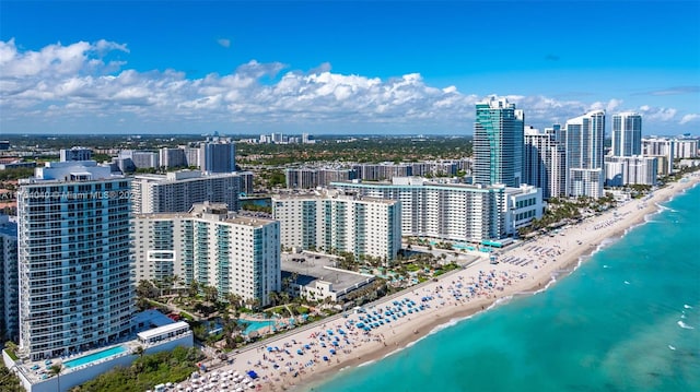 aerial view featuring a view of the beach, a city view, and a water view