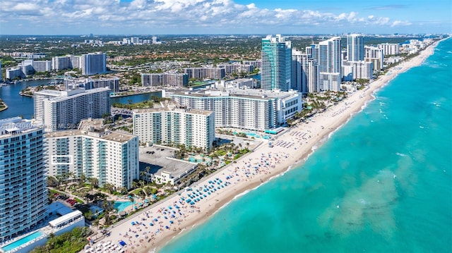 aerial view featuring a beach view, a water view, and a city view