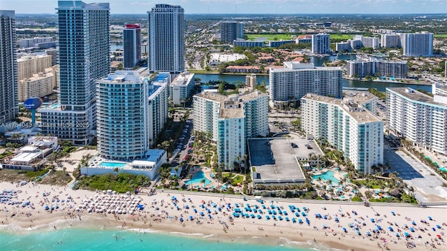 aerial view with a beach view, a water view, and a city view