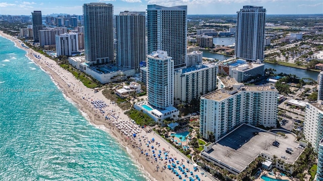 aerial view with a water view, a view of the beach, and a city view