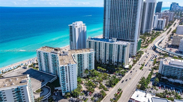 birds eye view of property featuring a city view, a water view, and a beach view