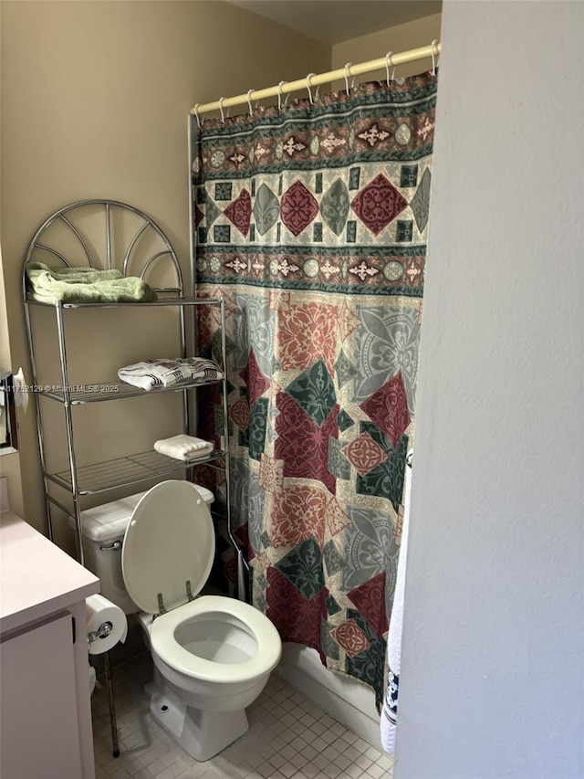 bathroom with tile patterned flooring and toilet