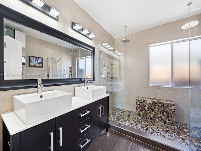 bathroom featuring a healthy amount of sunlight, a sink, and a shower stall