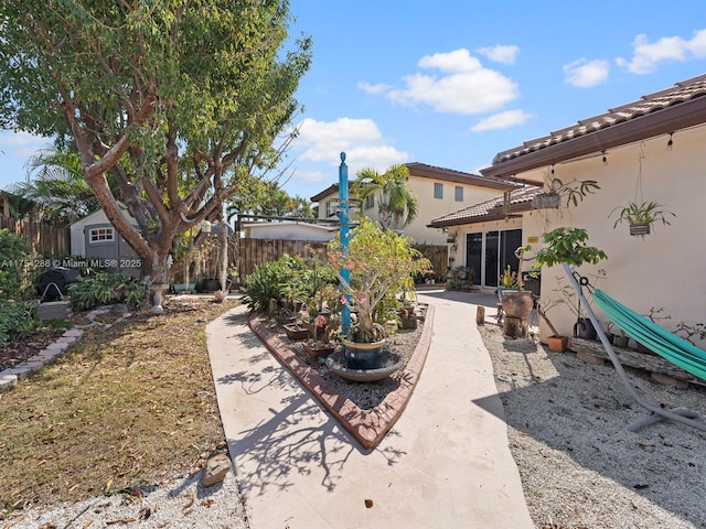 view of yard featuring fence and a patio