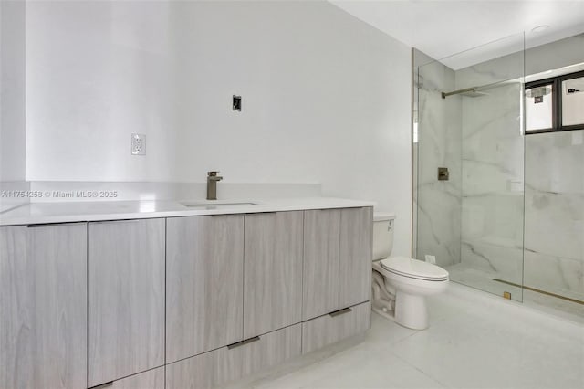 full bath with toilet, vanity, a marble finish shower, and tile patterned floors