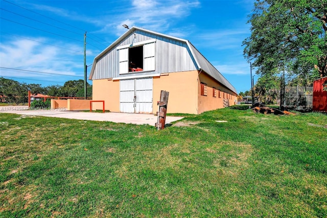 view of barn with a yard