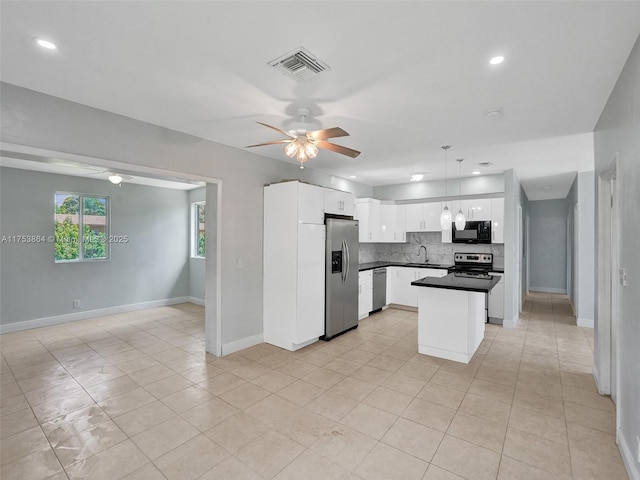 kitchen featuring a ceiling fan, visible vents, stainless steel appliances, white cabinets, and tasteful backsplash