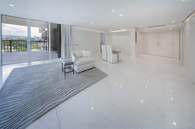 interior space with expansive windows, marble finish floor, and recessed lighting