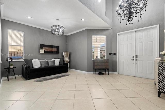 entrance foyer featuring plenty of natural light, baseboards, tile patterned floors, an inviting chandelier, and crown molding