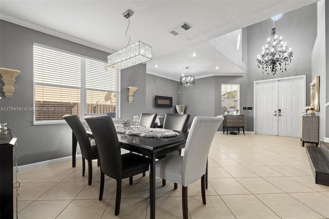 dining area featuring plenty of natural light, a notable chandelier, and crown molding