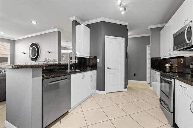 kitchen featuring stainless steel appliances, decorative backsplash, white cabinets, light tile patterned flooring, and a sink