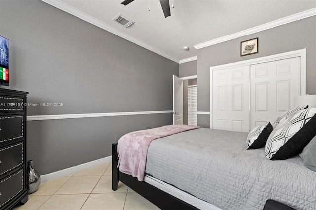 bedroom with baseboards, visible vents, ornamental molding, a closet, and light tile patterned flooring