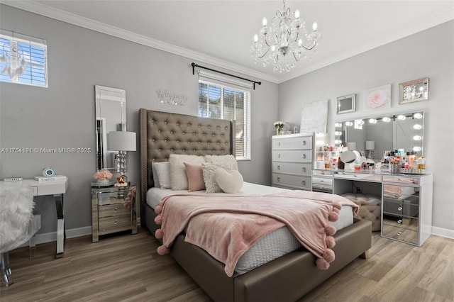 bedroom with ornamental molding, a chandelier, baseboards, and wood finished floors