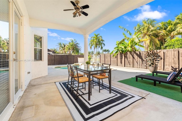 view of patio / terrace with a fenced backyard, a ceiling fan, and outdoor dining space