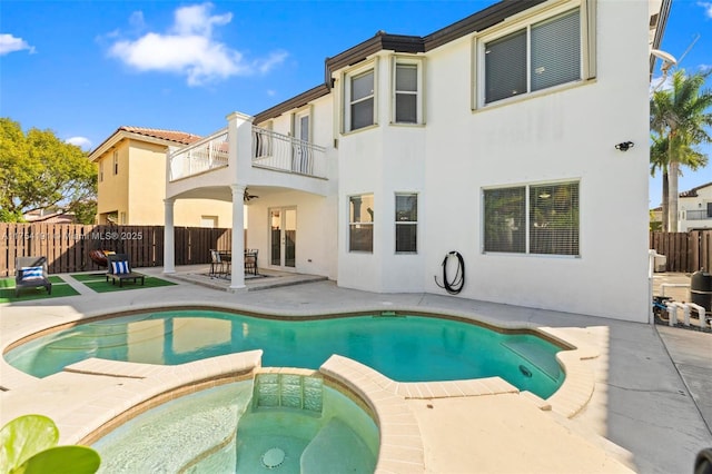 back of property featuring a patio area, fence, a balcony, and stucco siding