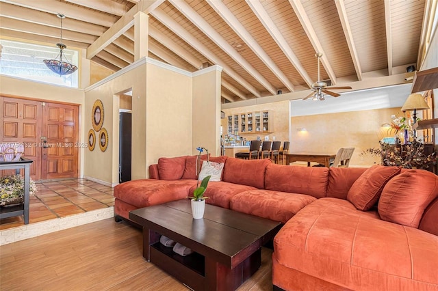 living area featuring high vaulted ceiling, beam ceiling, baseboards, and light wood finished floors