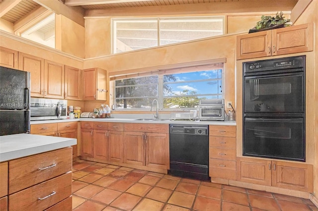 kitchen with lofted ceiling with beams, wood ceiling, light countertops, black appliances, and a sink