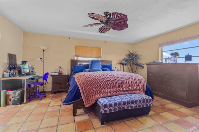 bedroom with ceiling fan and light tile patterned floors