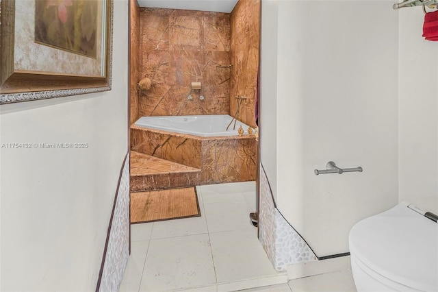 full bath featuring tile patterned flooring, toilet, and a bath