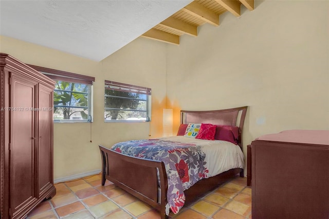 bedroom featuring lofted ceiling with beams