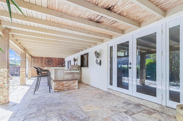 view of patio / terrace with outdoor wet bar, french doors, and area for grilling