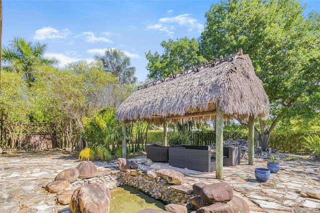 view of property's community with a patio area, fence, an outdoor living space, and a gazebo