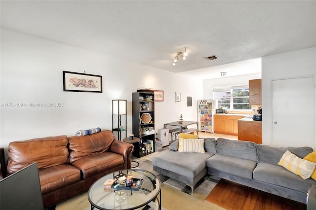 living room featuring light carpet and visible vents