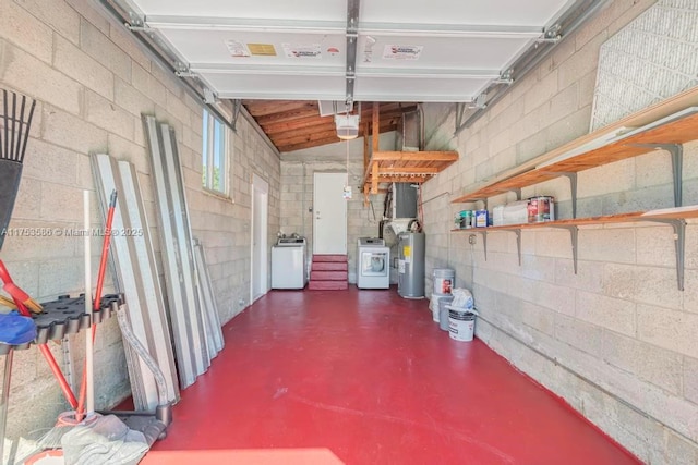 garage with washing machine and dryer, a garage door opener, and electric water heater