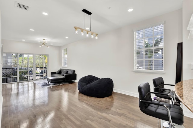 home office with baseboards, visible vents, wood finished floors, a notable chandelier, and recessed lighting