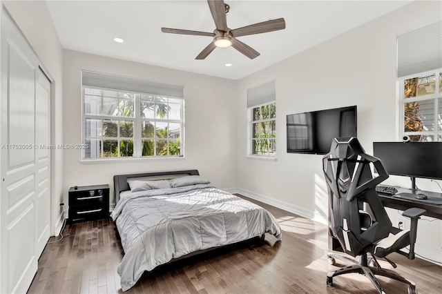 bedroom with recessed lighting, a closet, a ceiling fan, wood finished floors, and baseboards