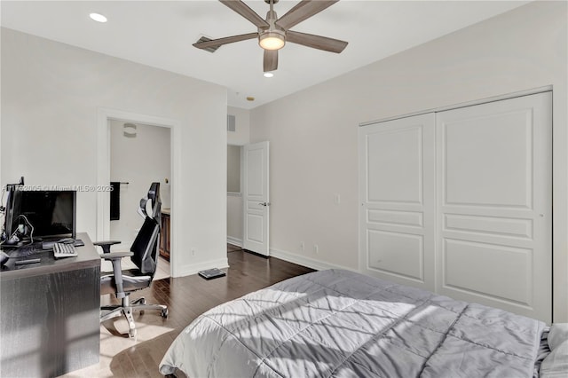 bedroom with recessed lighting, wood finished floors, visible vents, baseboards, and a closet