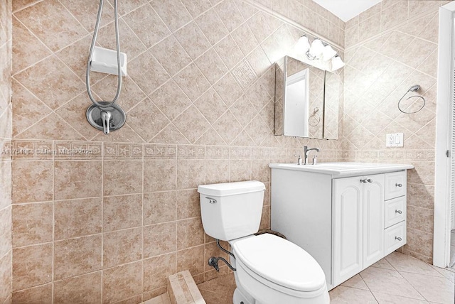 full bath featuring tile patterned flooring, tile walls, vanity, and toilet