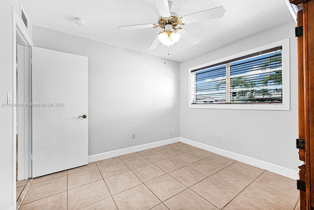 unfurnished room featuring visible vents, ceiling fan, baseboards, and light tile patterned floors