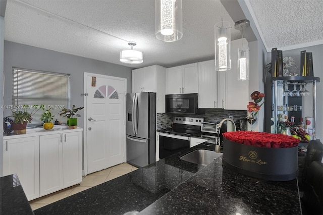 kitchen featuring white cabinets, light tile patterned floors, stainless steel appliances, and a sink