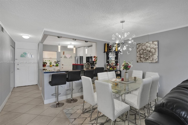 dining room with crown molding, light tile patterned floors, visible vents, an inviting chandelier, and a textured ceiling