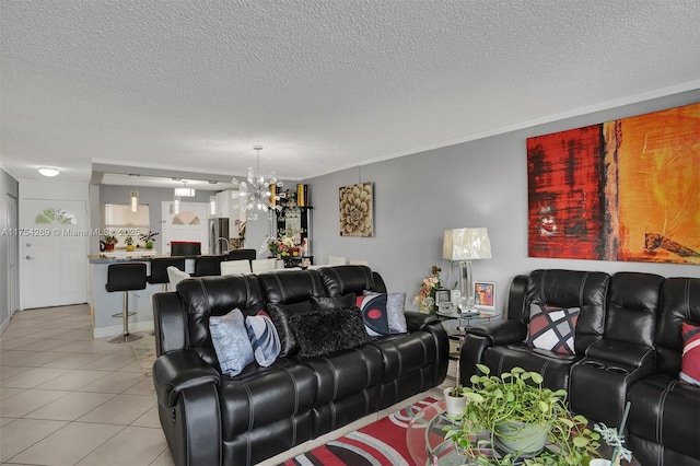 living area featuring crown molding, a textured ceiling, an inviting chandelier, and light tile patterned floors