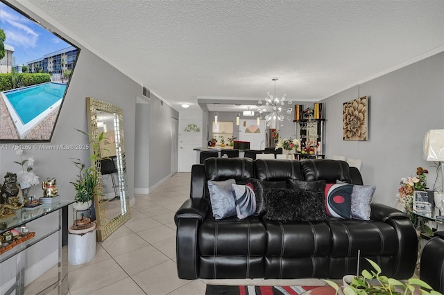 living area with visible vents, crown molding, a textured ceiling, a notable chandelier, and light tile patterned flooring